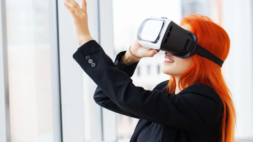 woman-virtual-reality-headset-pointing-air-while-her-working-place-office